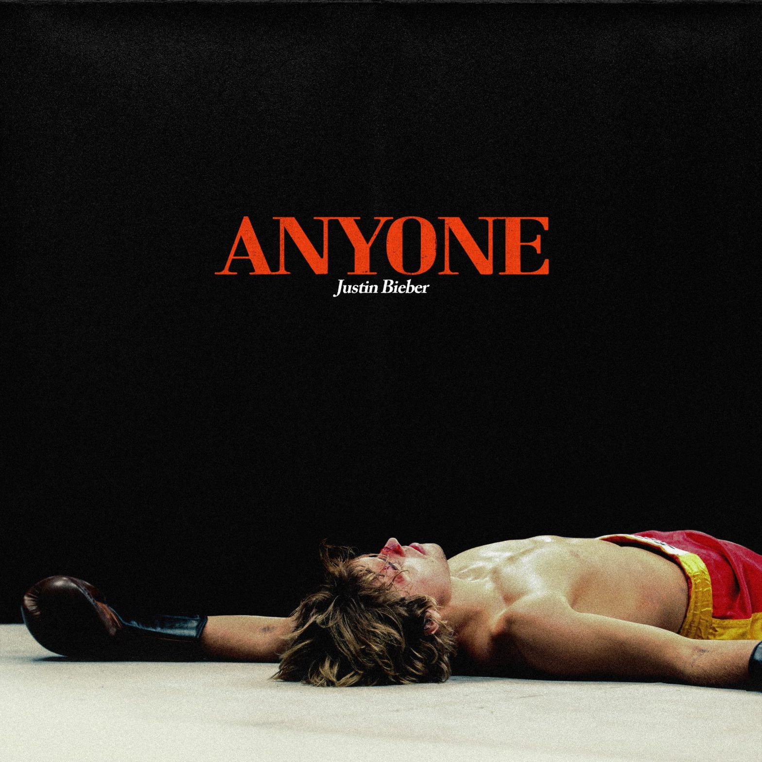 cover of the single for Justin Bieber's song Anyone; he's dressed as a boxer and he's lying on the floor, like he got knocked out. His face is bloody.